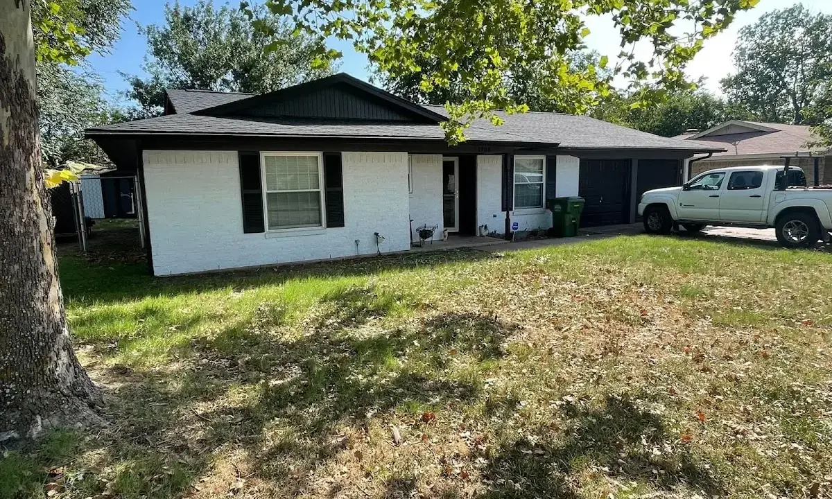 Professional roofing crew working on a residential roof in Bolivar